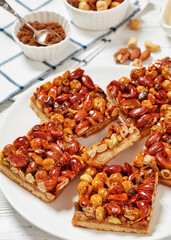 toffee mixed nuts shortbread bars on white plate