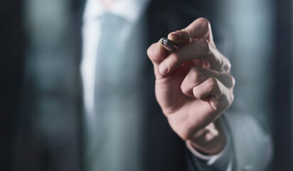 Fototapeta premium right hand writes with a marker on a transparent board on a black background