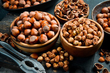Nuts background. Freshly harvested hazelnut. On a black stone background.