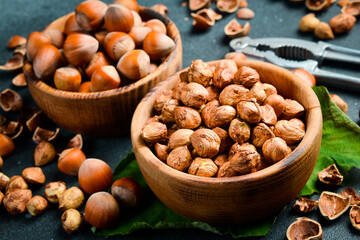 Hazelnuts in a wooden bowl. Hazelnut nut health organic brown filbert autumn background concept. Close up.