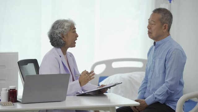 A female doctor is giving advice to an elderly man in the waiting room. Relaxed atmosphere Concept of health care, mental health