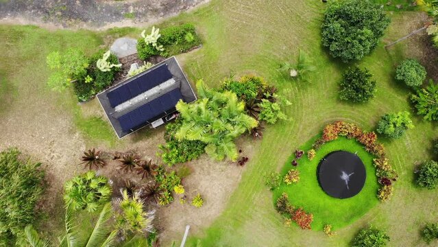 Birds eye view of off grid water catchment tank and solar power building.