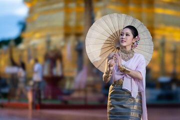 Pretty Asian women wearing beautiful Thai traditional dress in Hundred Thousand Lantern Festival or...