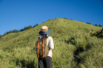 Fototapeta na wymiar Hike trail hiker woman walking over the mountain