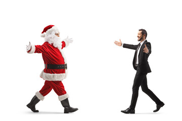 Full length profile shot of santa claus meeting a businessman
