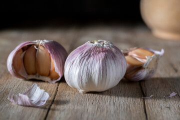 Unpeeled garlic on a wooden table