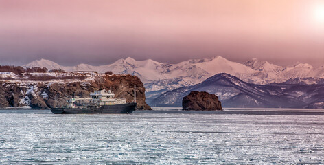 Hydrological vessel off the coast of the Kamchatka peninsula in Avacha Bay at sunset