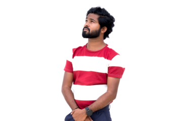 a man with a beard and a red and white shirt is standing with his hands in his pockets and looking up