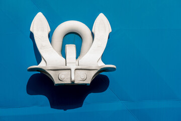 Anchor hanging on the boats blue board
