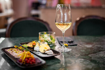 Obraz na płótnie Canvas tasting set appetizer food and white wine glass