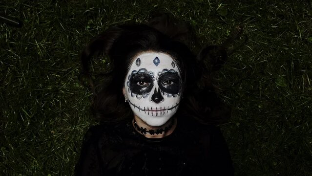 Girl with a sugar skull face. Halloween and All Saints holiday concept.
