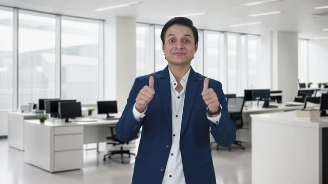 Happy Indian businessman showing thumbs up