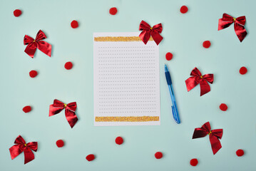 Christmas holiday concept. Blank sheet of paper with pen on blue background with Christmas decorations. Santa's List Day