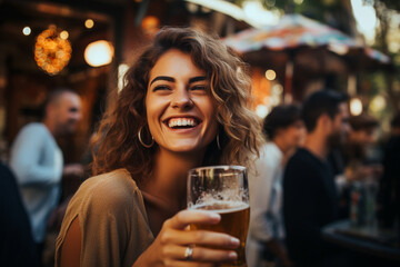 Naklejka premium Happy Woman on a Bar Terrace Enjoying a Beer and Smiling