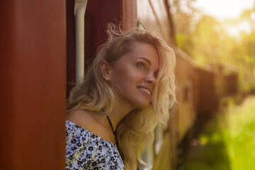 Smiling traveler woman travel to sri lankan extreme train in Sri Lanka, looking up away. Happy lady tourist enjoy trip train ride by landmarks. Touristic journey tropical concept. Copy ad text space