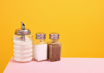 Glass jars with salt, sugar and ground black pepper. Copy space for text. Delicious dinner.
