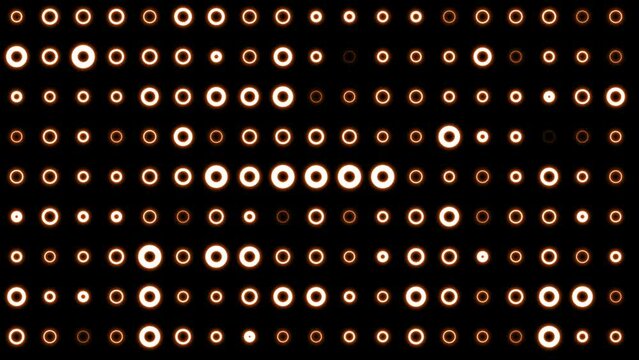 Abstract background of bright orange yellow glowing light bulbs from circles and dots of energy magic disco wall