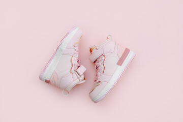 Children's sneakers. Baby sneakers on pink background. .Trendy sneakers for kids for spring and autumn. Fashion kids outfit.