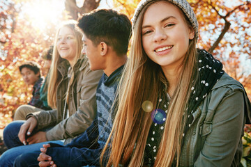 Teenager, group and portrait in park, girl and diversity on holiday, nature and relax by trees. Youth culture, happy friends and gen z school kids in sunshine, woods or garden for vacation in Canada