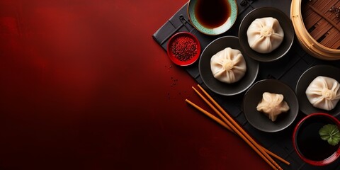 Obraz na płótnie Canvas An elegant flat lay showcases beloved Chinese cuisine: delicate dim sum, hearty noodles, and a pot of warm tea, with an intentional empty space for custom text or designs.