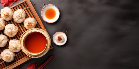 Obraz na płótnie Canvas An elegant flat lay showcases beloved Chinese cuisine: delicate dim sum, hearty noodles, and a pot of warm tea, with an intentional empty space for custom text or designs.
