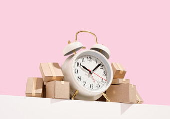 Vintage white alarm clock and many cardboard boxes. Moving time.