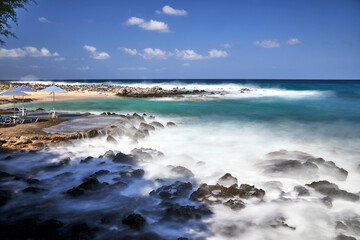 Umbrellas on the rocky beach in Stavros on the island of Crete