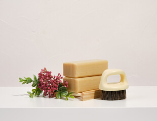 Natural soap for personal hygiene and a brush. Bathroom accessories.