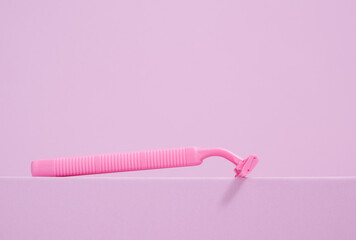 Pink razor and daily hygiene. Copy space for text.