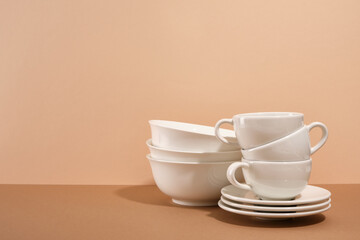 Set of clean white empty tableware. Clean cups and plates. Copy space for text.