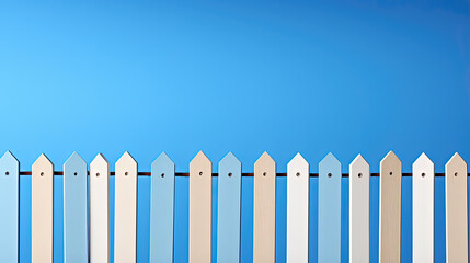 A wooden barrier with white and blue stakes on a blue sky background