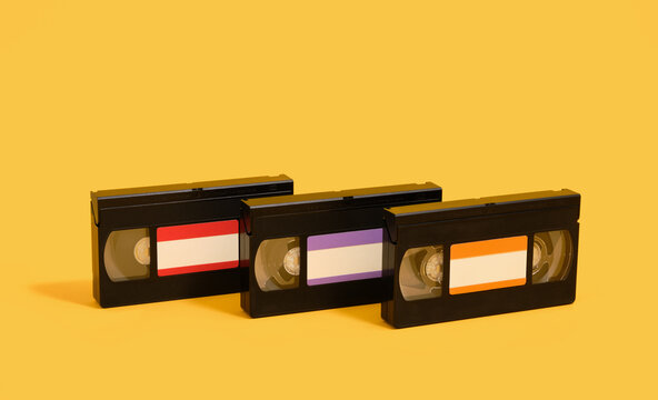 Three black videotapes on a yellow background. Movie time.