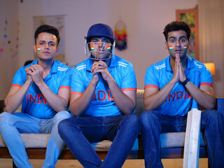 Three friends are watching a live cricket match on television - praying for team victory in tense...