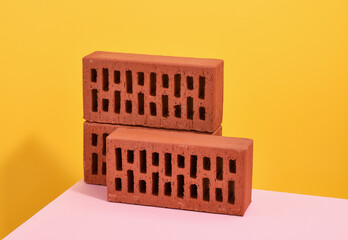 Facing bricks for building construction lie on the surface.