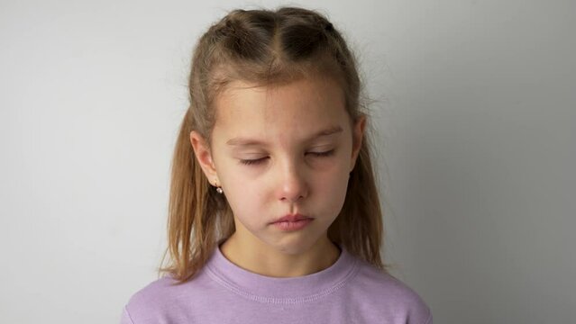 Portrait of little child girl looking at camera, white background