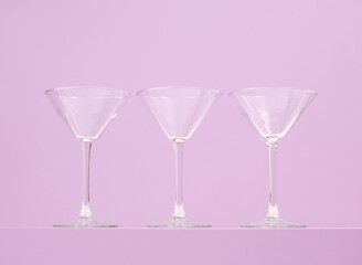 Three empty glasses stand in a row. Alcohol, cocktails and drinks.