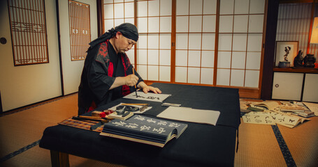 Japanese Male Calligraphy Artist Drawing Artistic Symbols in Kanji Characters. Zen Master or Monk...