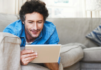 Man, relax and tablet internet on sofa for digital contact, social media or movie app. Male person,...