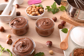 Table with ingredients in bowls to make homemade hazelnut cream