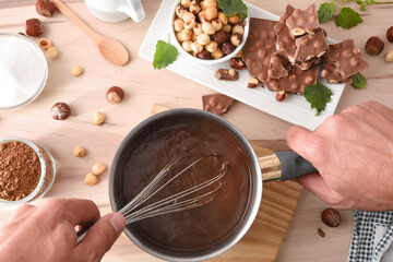 Making homemade hazelnut chocolate on the kitchen bench with ingredients