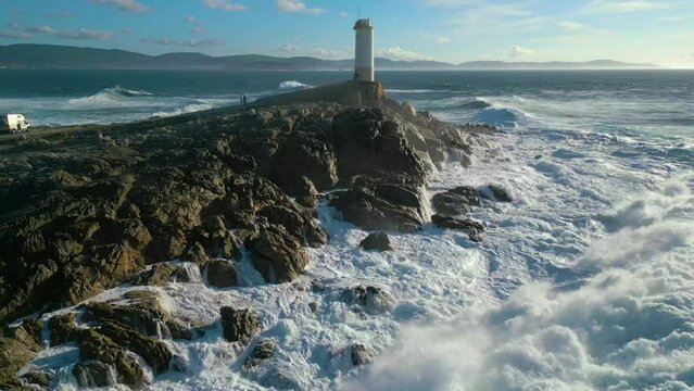 Turbulent Water Crashing On The Rocky Coast Shore Of Faro de Cabo Roncudo In Corme, Coru&ntilde;a, Spain. aerial