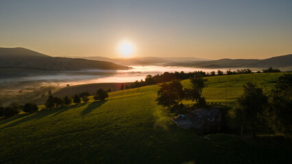 Beautiful scenery of sunrise in czech mountains with meadows, forest and concrete bunker