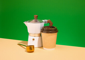 Coffee break and geyser coffee maker. Cup hot coffee and gold coffee spoon.
