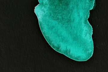 Black and green abstract background. Colorful ink blots and stains, wallpaper print. Creative backdrop, chaotic paint brushstrokes, pattern for printing on card.