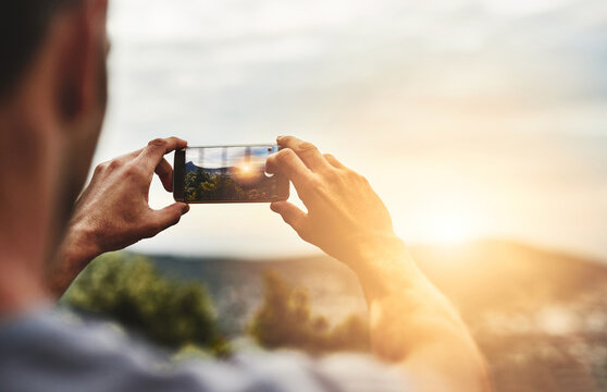 Sunset, photography and hands of man with phone, screen and post on social media of nature, landscape or sun. Cellphone, photo and person with tech for memory of vacation, holiday or outdoor view