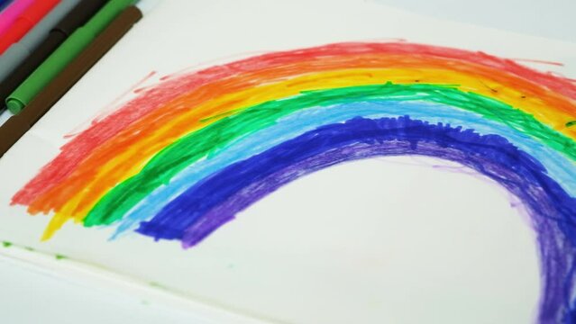Drawing of a rainbow drawn with felt-tip pens in a sketchbook by a small child