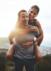 Portrait, piggy back and couple with love, outdoor and lens flare with happiness, freedom and bonding. Face, man carrying woman and adventure with health, journey or outside with wellness or vacation