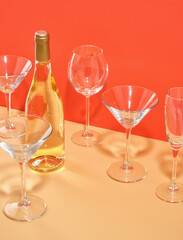A bottle of expensive, delicious luxury wine and many empty glasses on the table. Concept of party and celebration. Copy space for text.