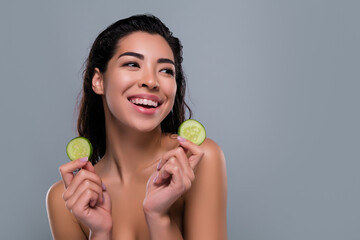Photo of stunning asian woman hold cucumber vegetables organic spa salon shoulders off isolated gray color background
