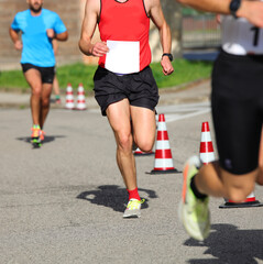 runner running during sports competition on the asphalt road in the city